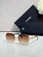 Square sunglasses with rose gradient lenses and gold-tone frames, with logo detail on temples.
