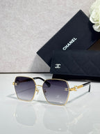Chanel sunglasses with gold square frame and dark purple lenses, mirrored detail on arms