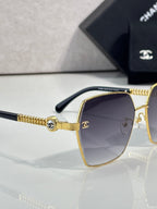 Chanel sunglasses side view: gold frame, dark gradient lenses, chain-like temple bar
