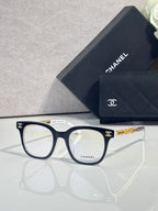 Dark blue square eyeglasses with gold CHANEL temple detail