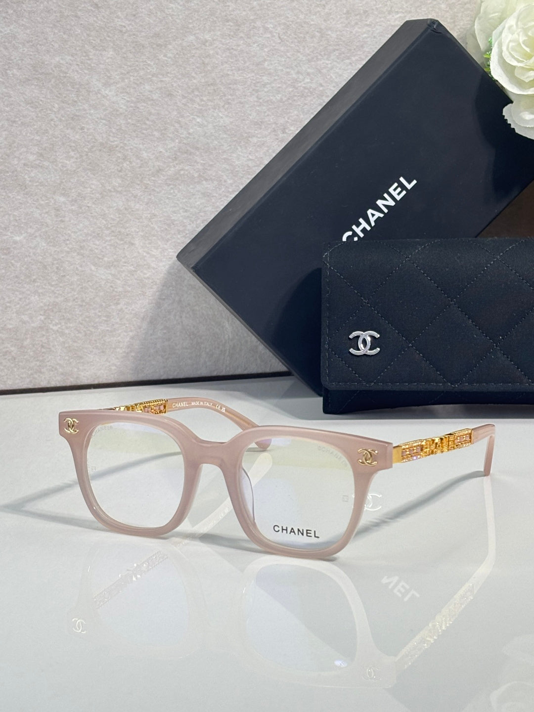 Pink square eyeglasses with gold logo temples, CHANEL branding