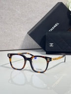 Tortoiseshell and dark blue square eyeglasses with gold CHANEL logo temples