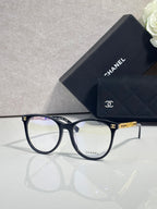 Chanel eyeglasses with dark blue frames and gold accents, clear lenses