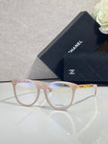 Chanel eyeglasses with light pink frames, gold accents, and clear lenses
