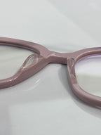 Light pink eyeglasses close-up of the frame bridge and hinge area