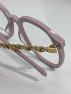 Light pink eyeglasses with gold chain connector on the frame temple