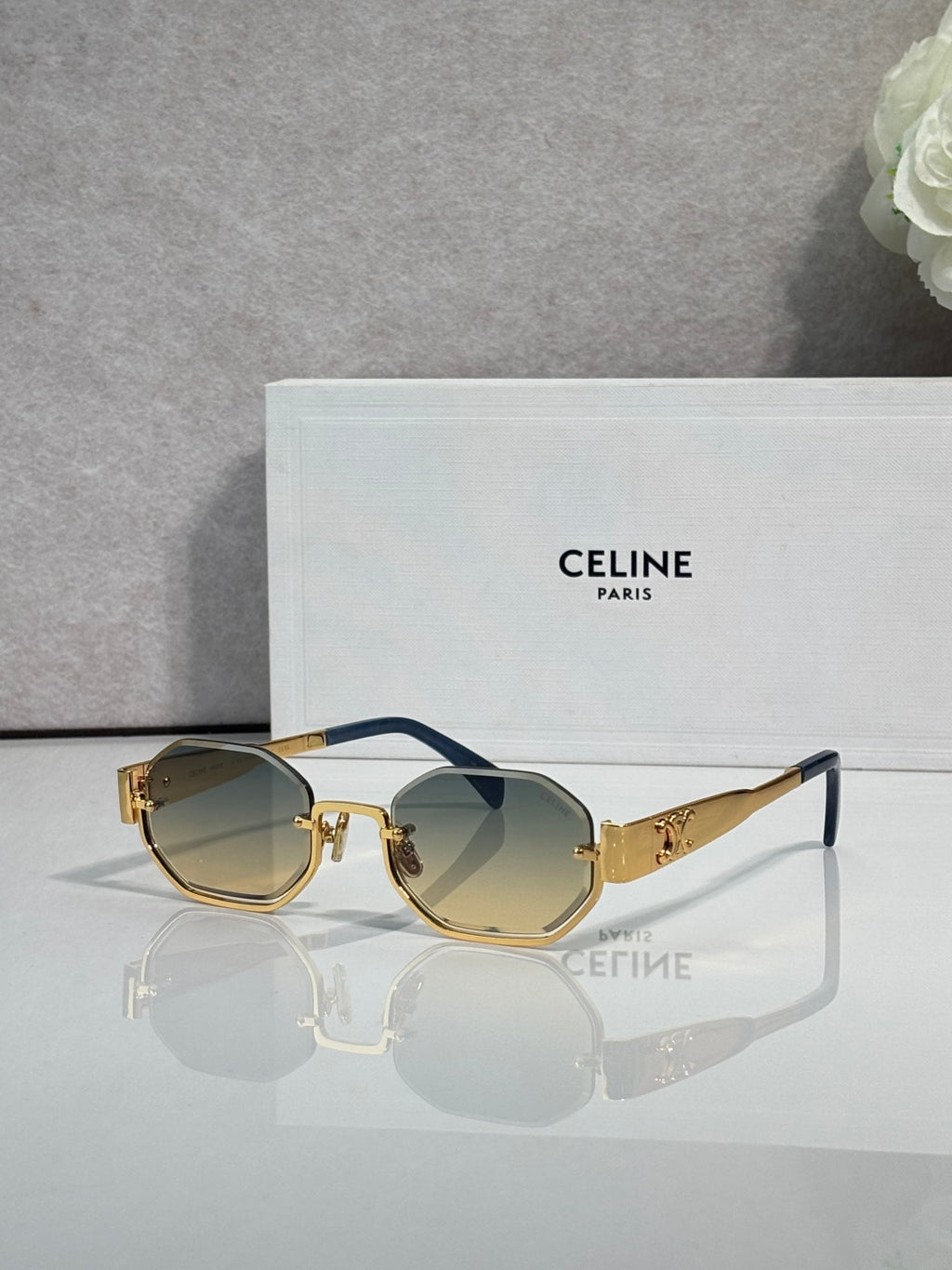Celine octagonal sunglasses with gold frame, tinted lenses, and blue temple accents