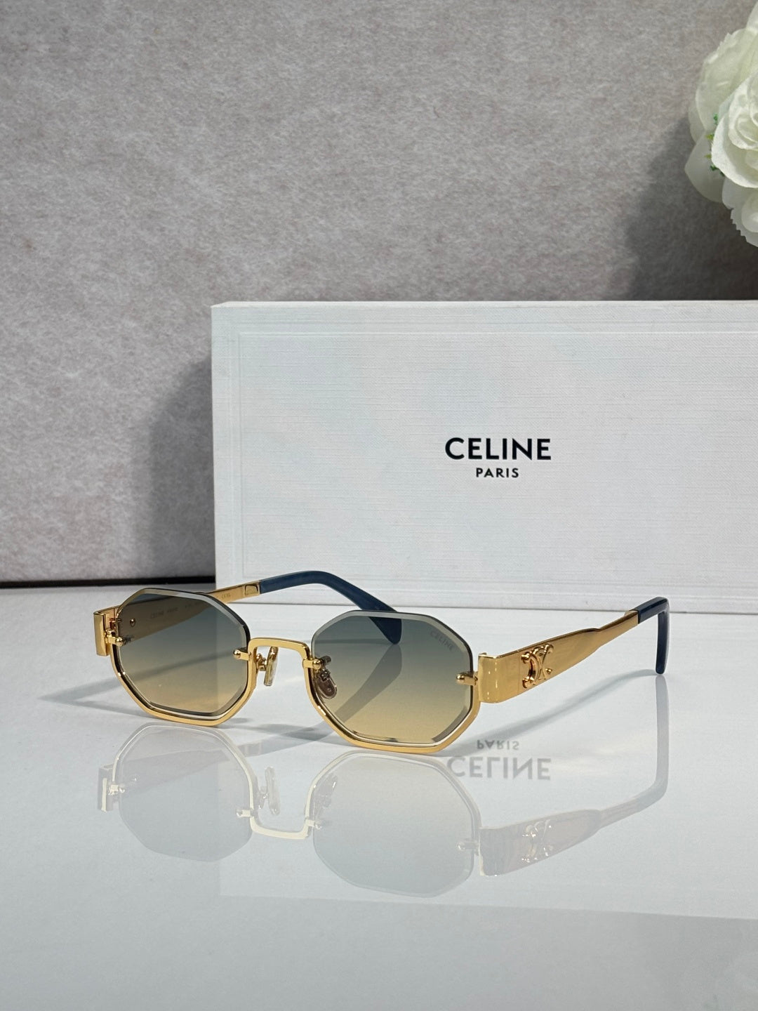 Celine octagonal sunglasses with gold frame, tinted lenses, and blue temple accents