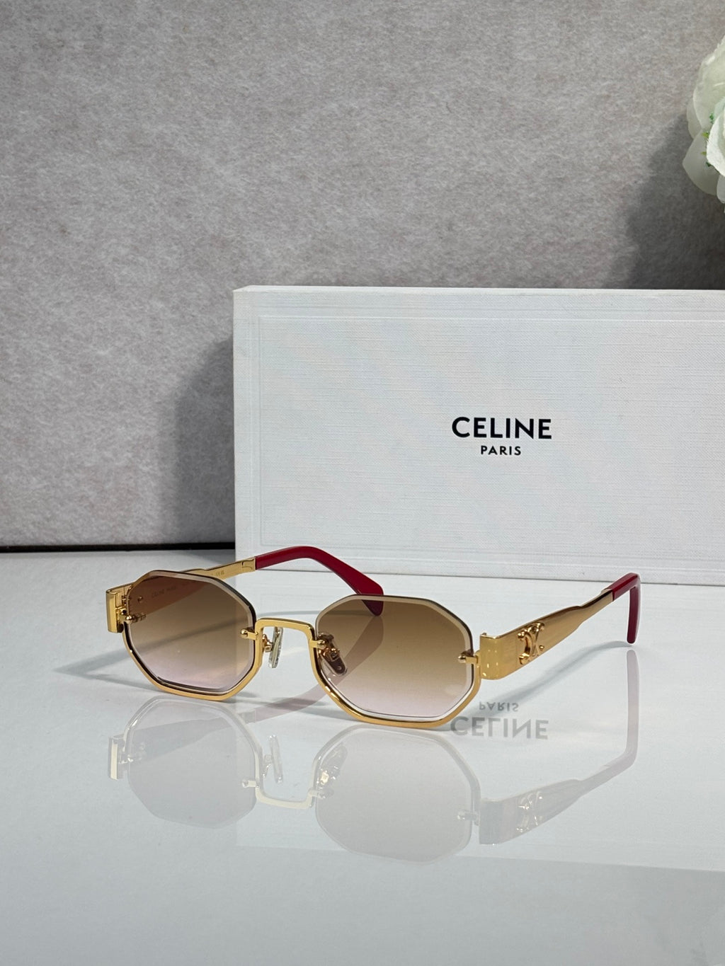 Celine octagonal sunglasses with gold frame, tinted lenses, and red temple accents