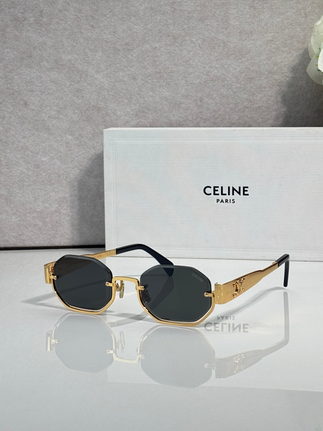 Celine octagonal sunglasses with gold frame, dark lenses, and black temple accents