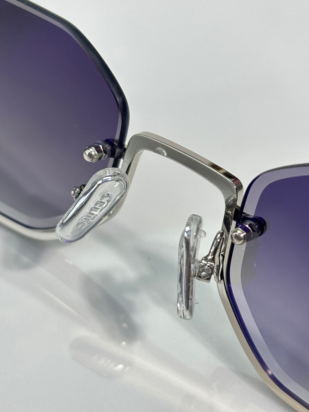 Celine sunglasses close-up with blue-tinted lenses and silver metal frame