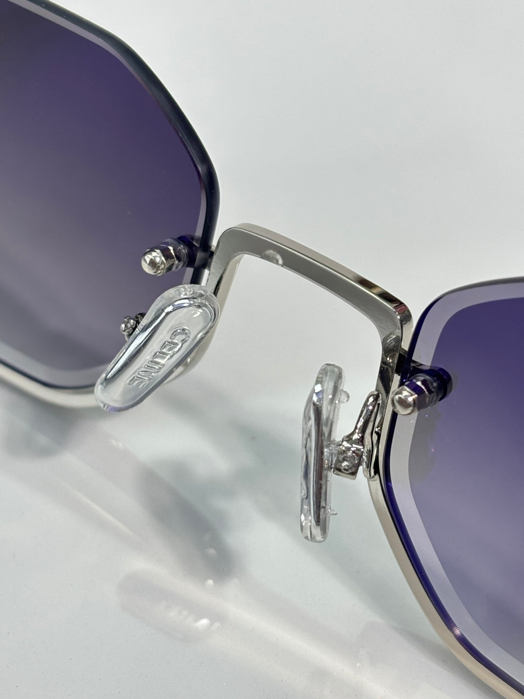 Celine sunglasses close-up with blue-tinted lenses and silver metal frame