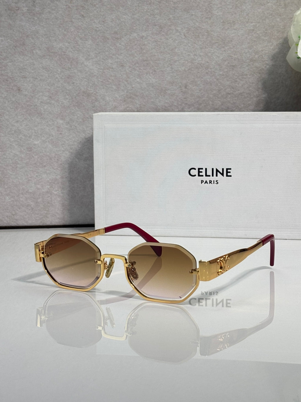 Celine glasses with gold-tone frame and burgundy temple, dark tinted lenses