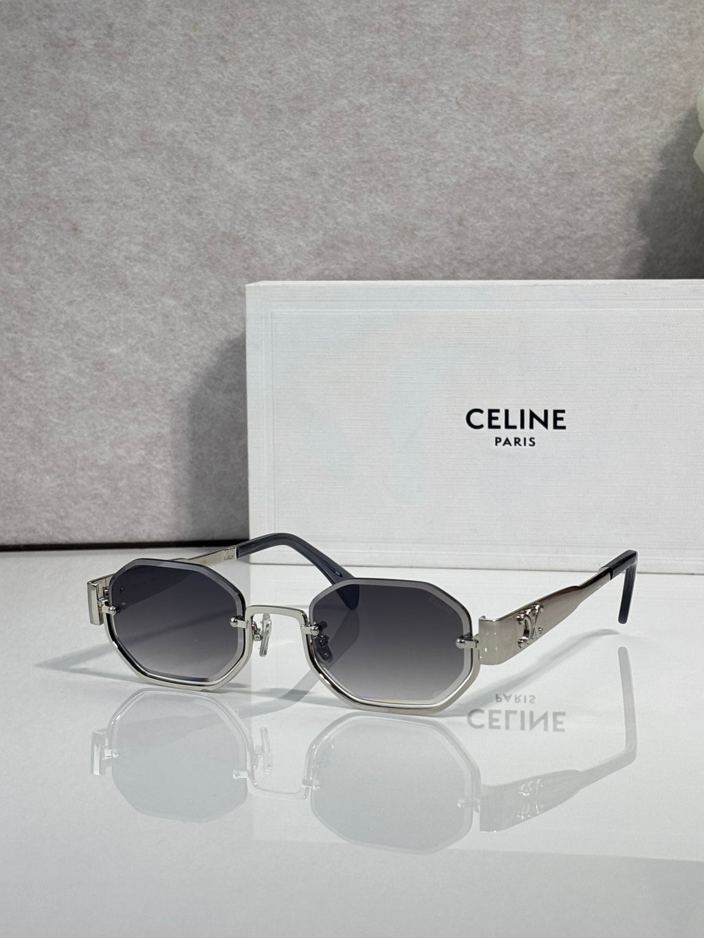 Celine glasses with black-tone frame and oval dark-tinted lenses