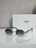 Celine glasses with black-tone frame and oval dark-tinted lenses