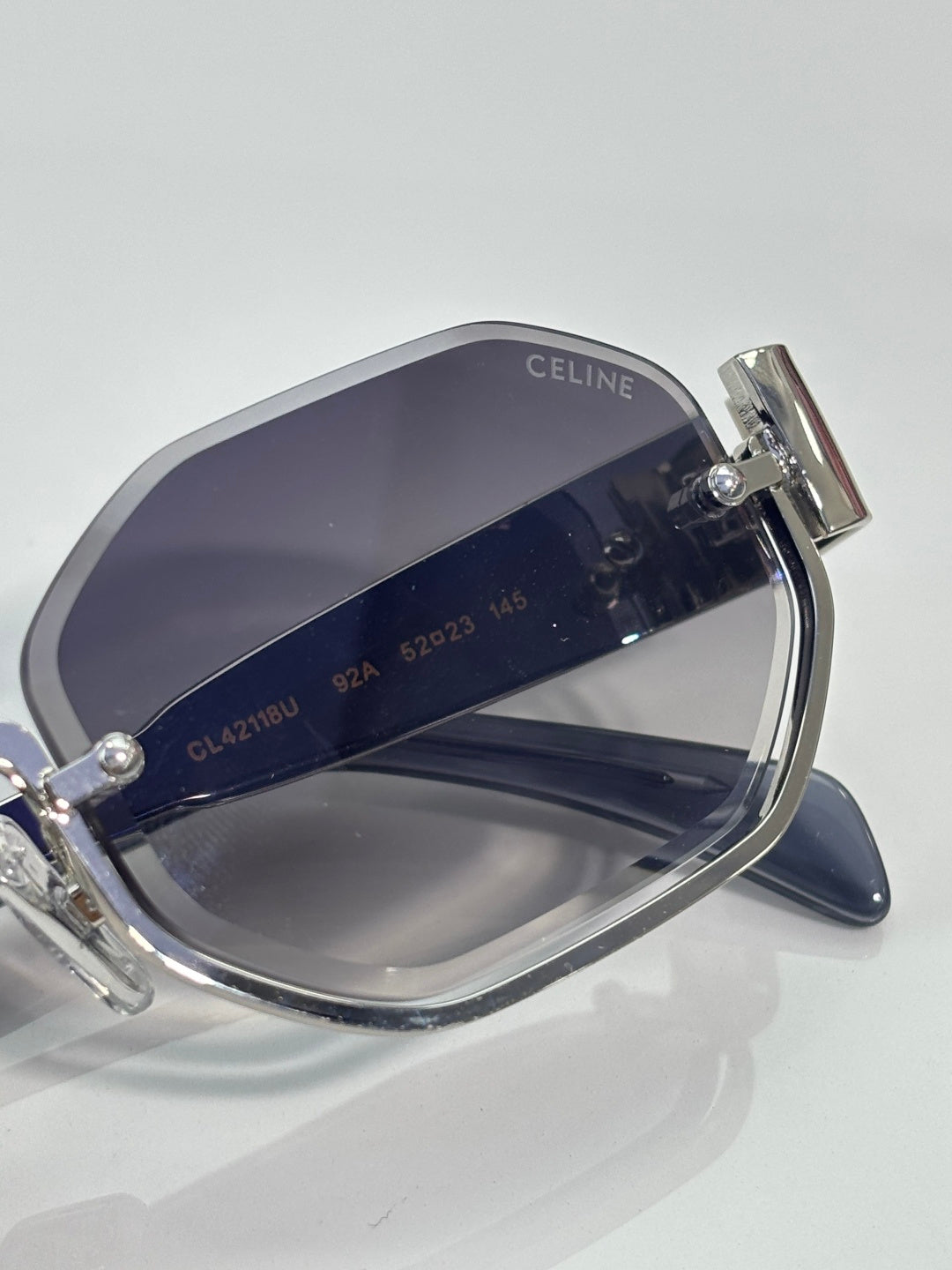 Celine glasses close-up of navy-tinted lens and silver frame