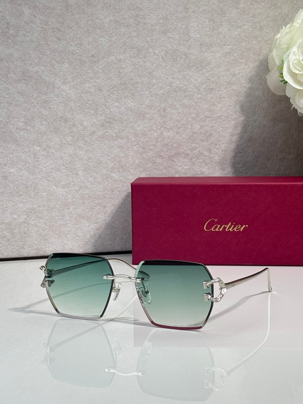 Cartier glasses with green gradient lenses and gold-tone cat-eye frame