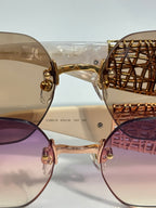 Chanel sunglasses close-up: gold frame bridge with round lenses and textured temple