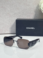 Chanel sunglasses with brown gradient lenses and gold metal frame, textured temple panels