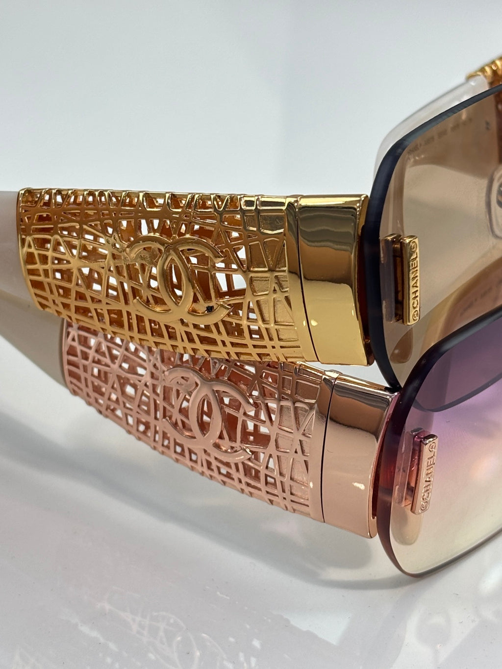Chanel sunglasses close-up: gold textured temple with lattice design and tinted lens