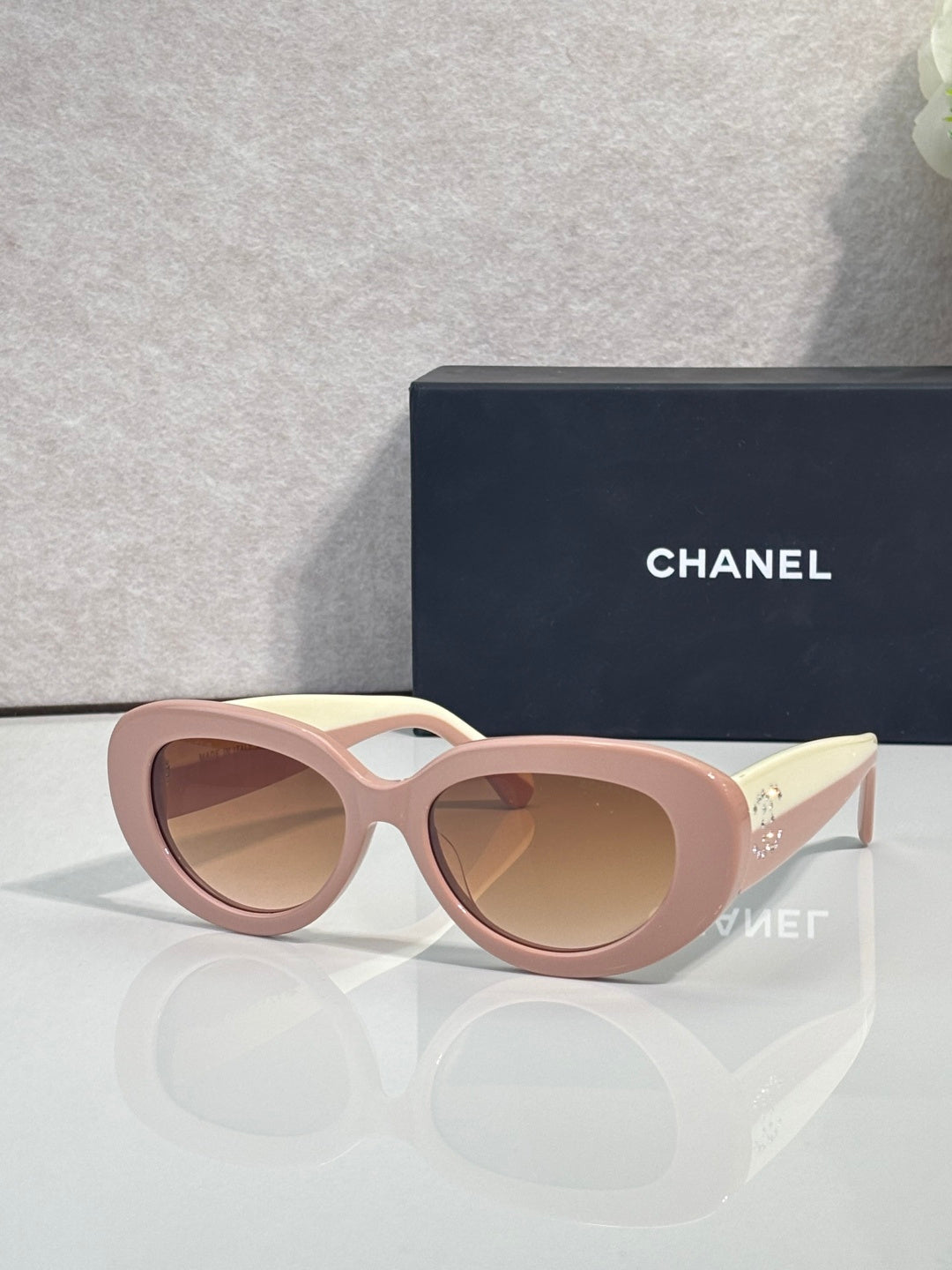 Pink round sunglasses with tinted lenses and gold-tone side arms