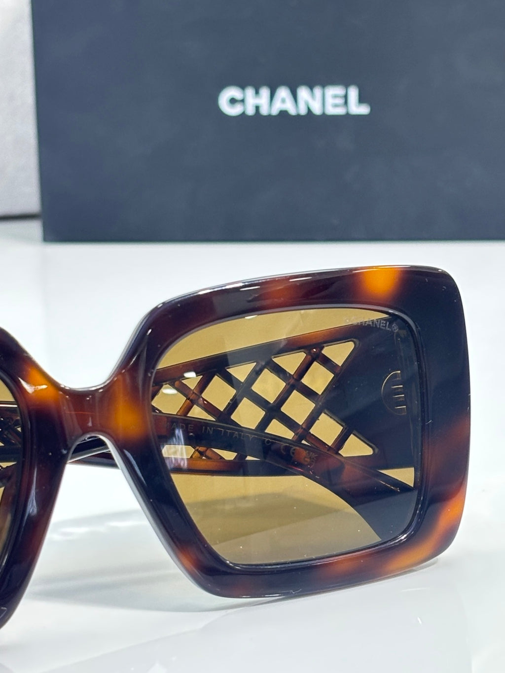 Chanel sunglasses close-up with tortoiseshell frame and gold lattice temple detail