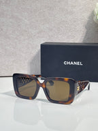 Chanel square sunglasses with tortoiseshell frame and gold logo detail on temple