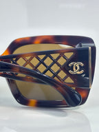 Chanel sunglasses front close-up with tortoiseshell frame and gold lattice detail