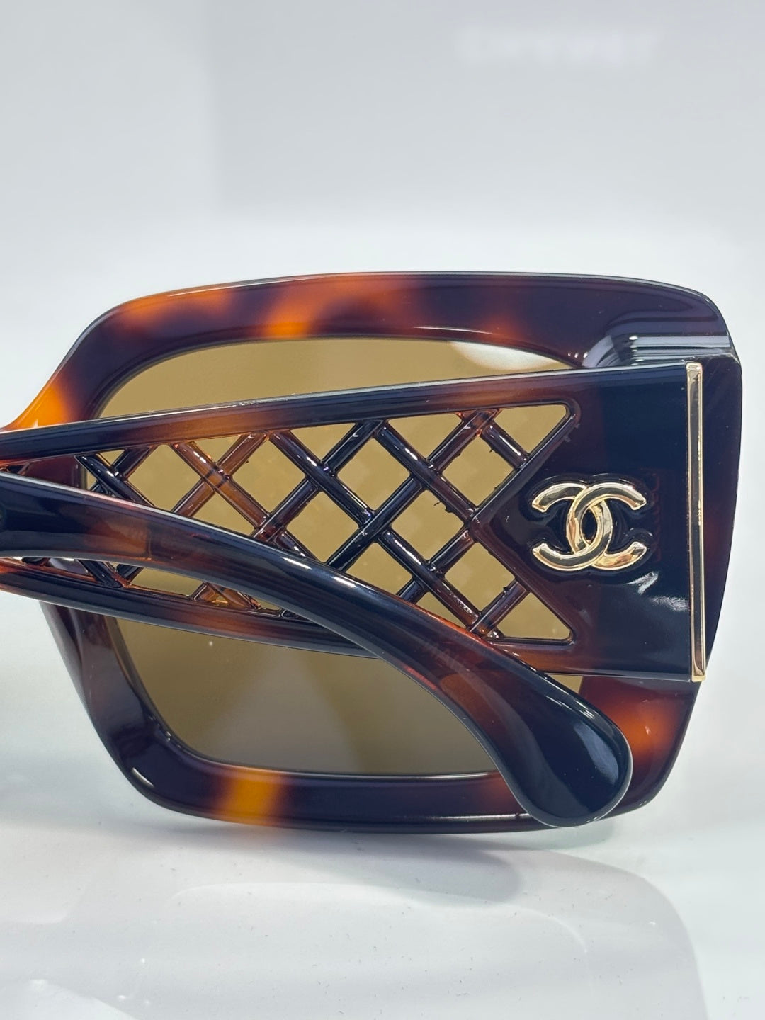 Chanel sunglasses front close-up with tortoiseshell frame and gold lattice detail