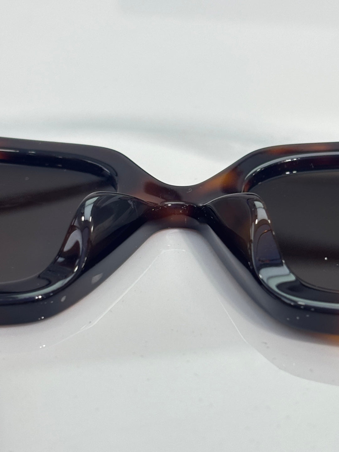 Chanel sunglasses close-up with dark gradient lenses and tortoiseshell frame
