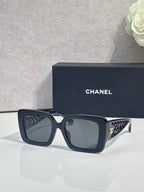 Chanel square sunglasses with dark frame and gold logo detail on temple