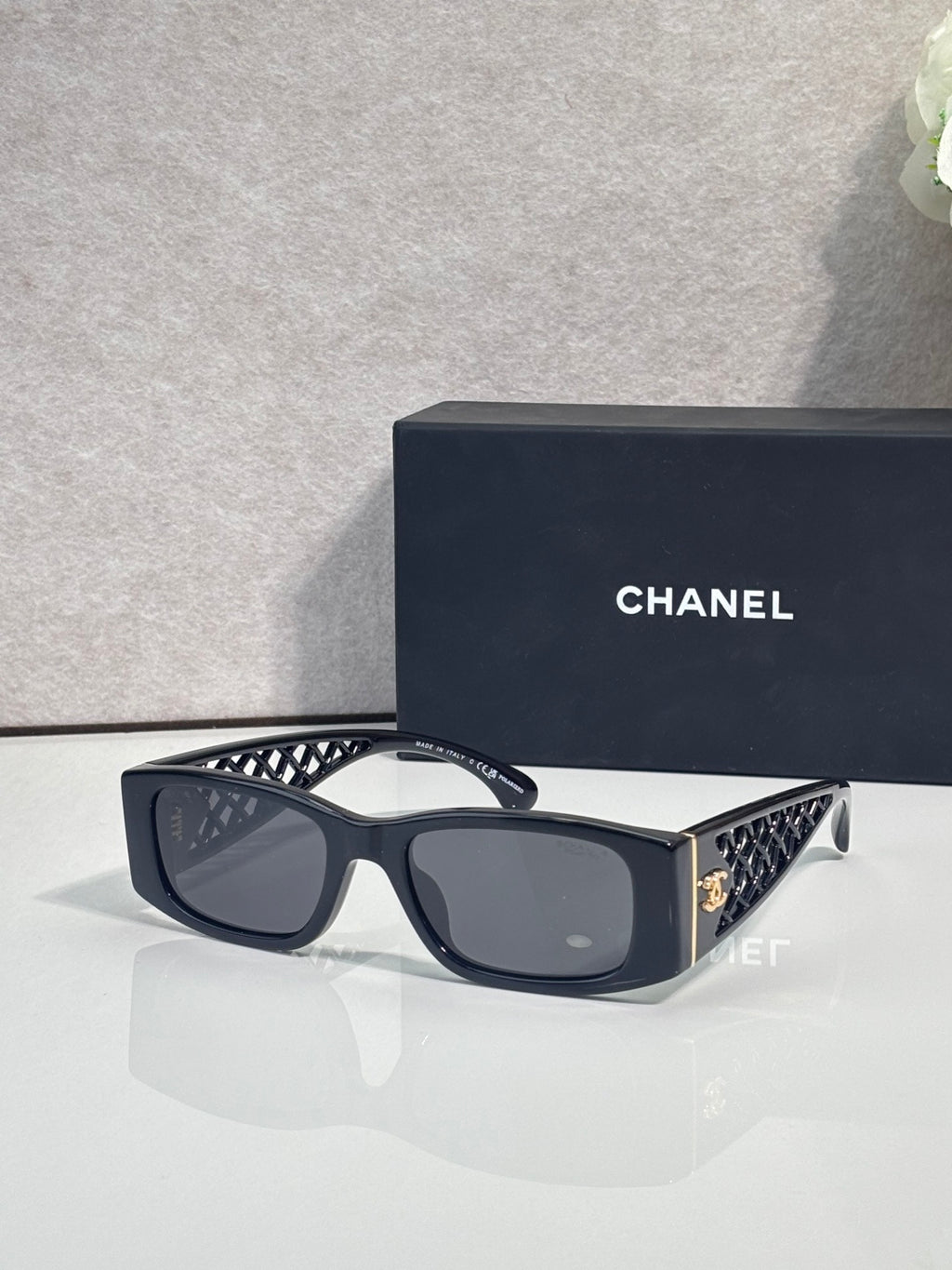 Black/blue sunglasses with dark lenses and geometric-pattern temples