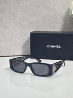Black/blue sunglasses with dark lenses and geometric-pattern temples