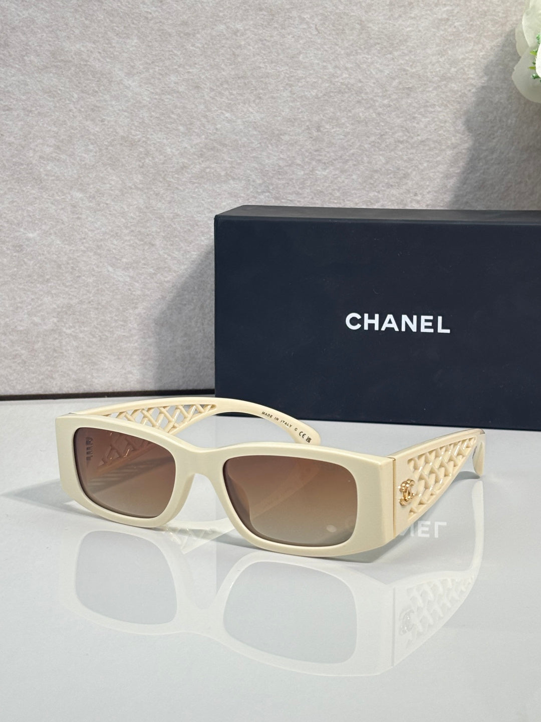 Cream square sunglasses with brown gradient lenses and diamond-pattern temple detailing