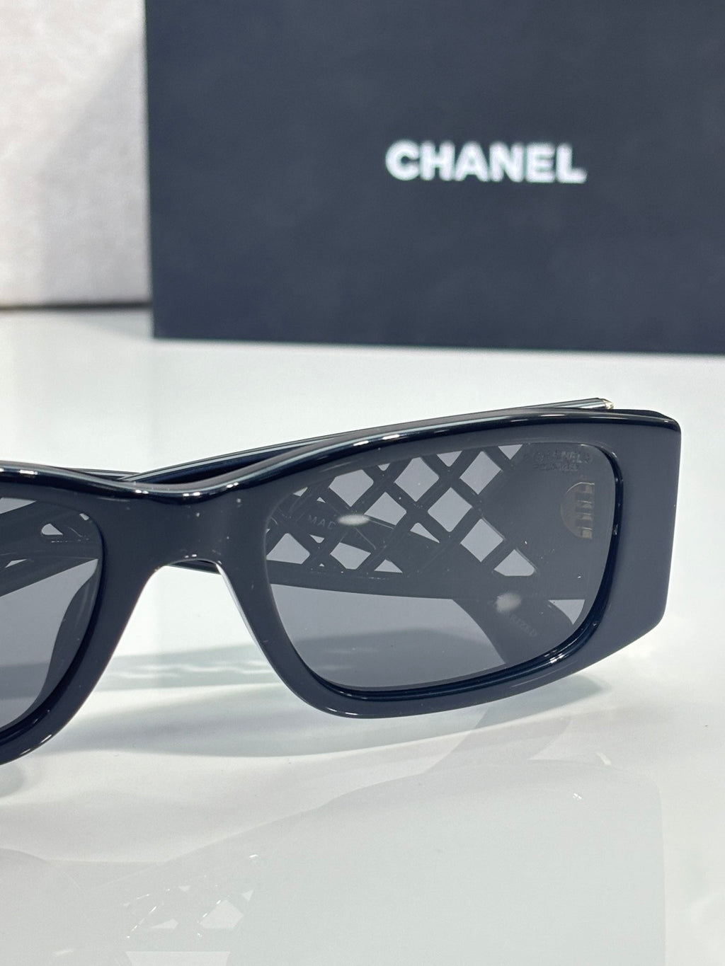 Navy sunglasses side view with dark gradient lenses and lattice temple styling