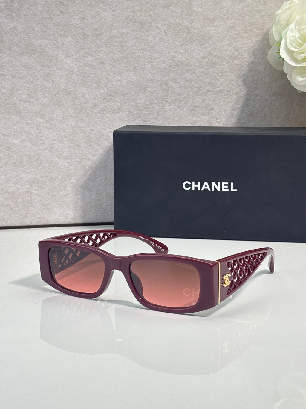 Burgundy sunglasses with rose gradient lenses and lattice-pattern temple detailing