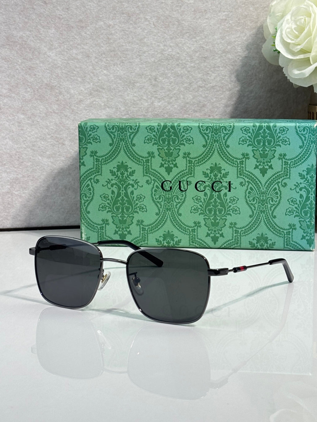Gucci sunglasses with black lenses and gold-tone frame