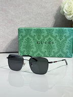 Gucci sunglasses with black lenses and gold-tone frame