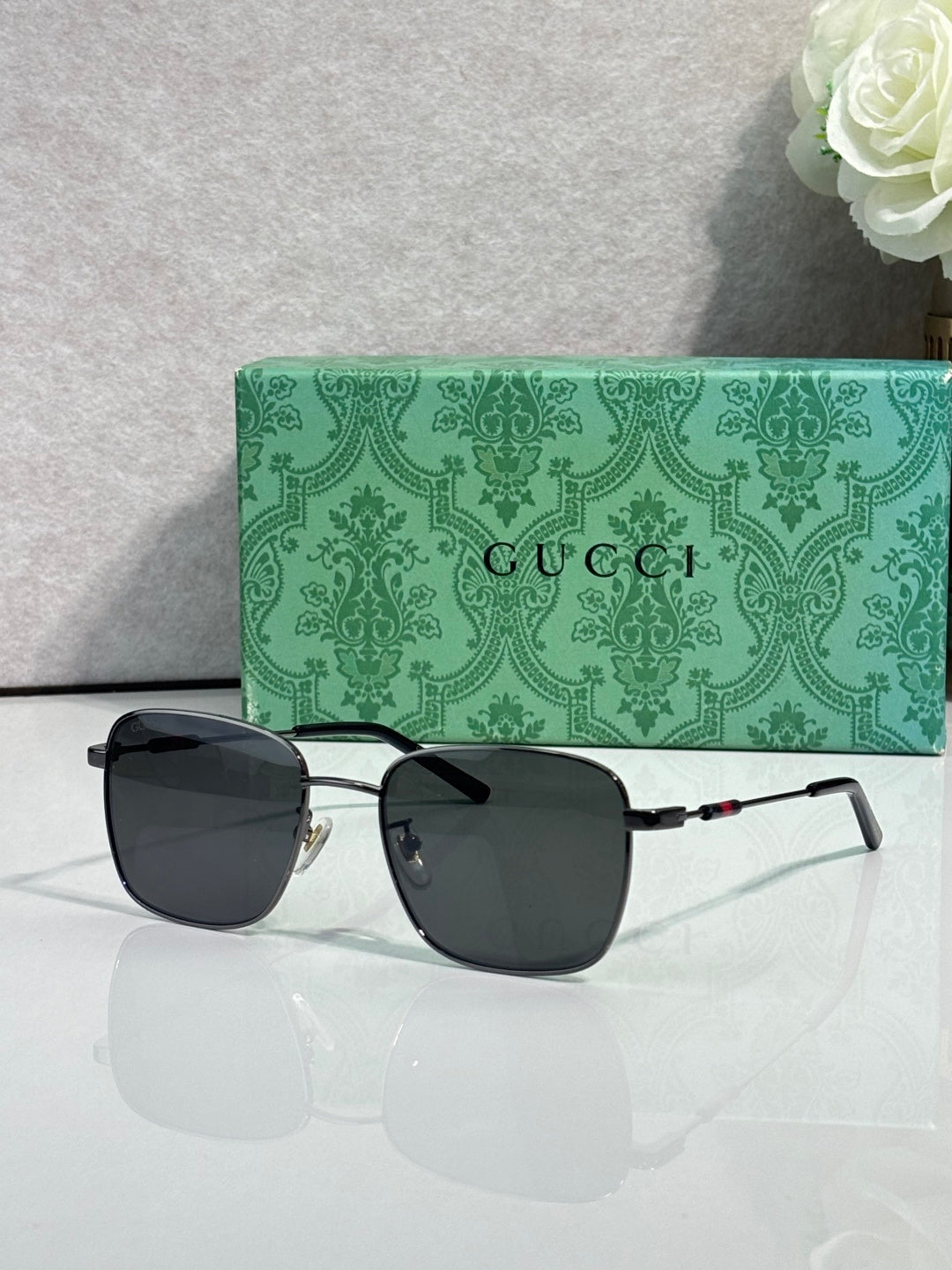 Gucci sunglasses with black lenses and gold-tone frame