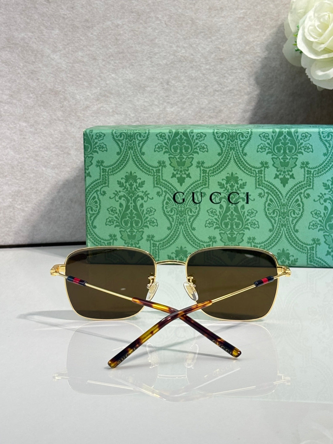 Gucci sunglasses with black lenses and gold-tone frame