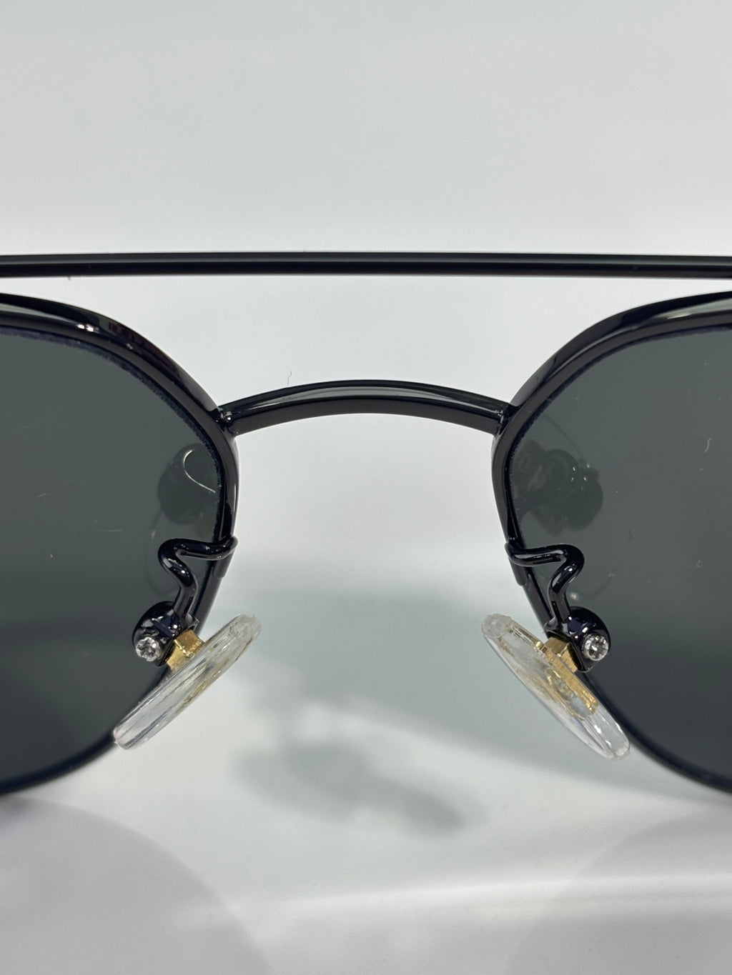 Gucci sunglasses close-up of black lenses and round front with rhinestone detail