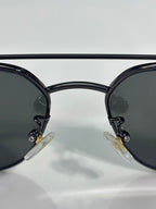 Gucci sunglasses close-up of black lenses and round front with rhinestone detail
