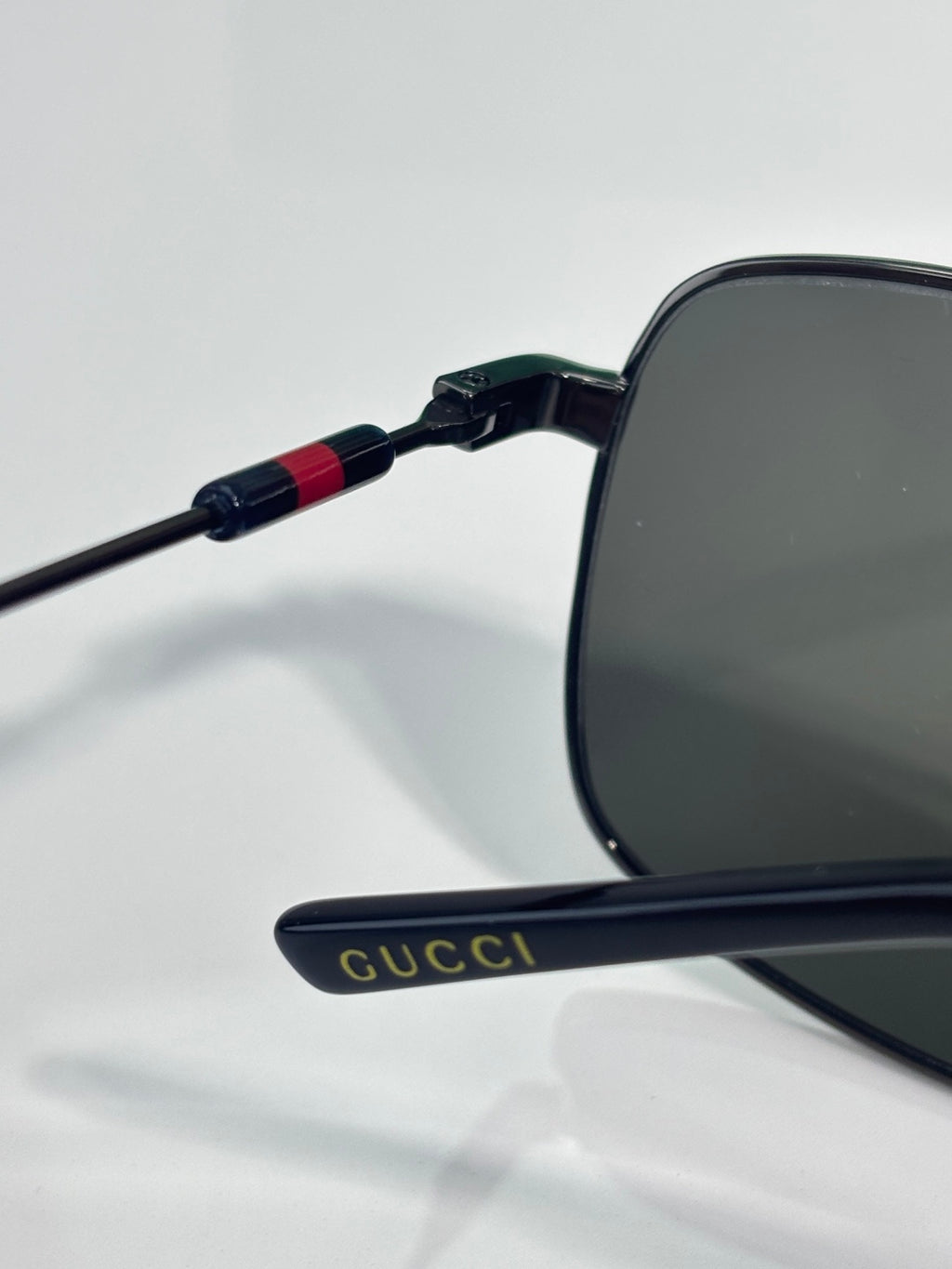 Gucci sunglasses side view with dark lenses and Gucci logo on temple