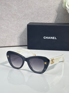 Chanel cat-eye sunglasses with dark blue frames and gold logo on temple