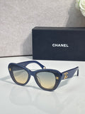 Chanel cat-eye sunglasses with dark navy frames and gold logo hardware