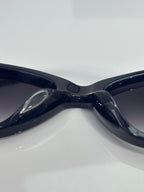 Close-up of dark sunglasses frame and nose bridge