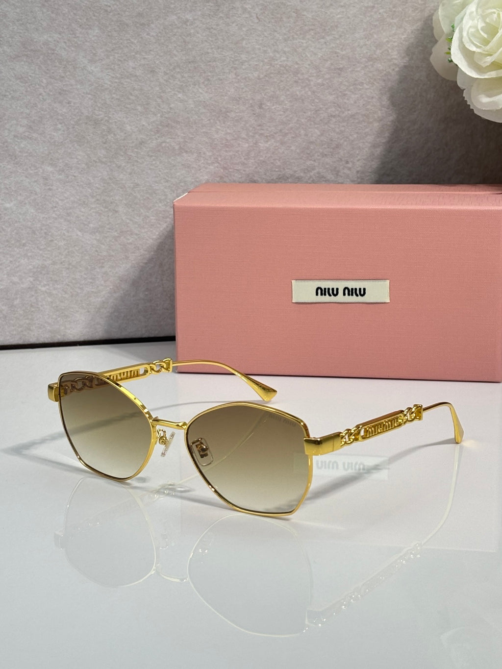 MiuMiu sunglasses, gold frame with tinted lenses
