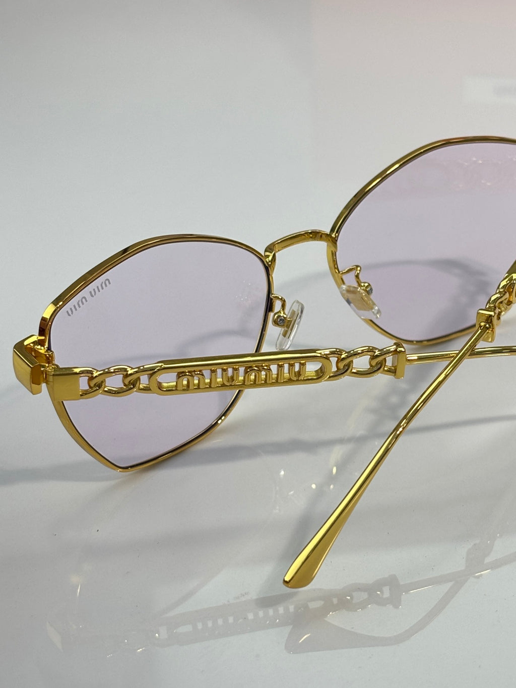 MiuMiu sunglasses, gold round-oval frames with engraved bridge
