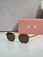 MiuMiu sunglasses with dark brown lenses and gold-tone rounded frames