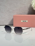 MiuMiu sunglasses with dark blue lenses and gold-tone rounded frames